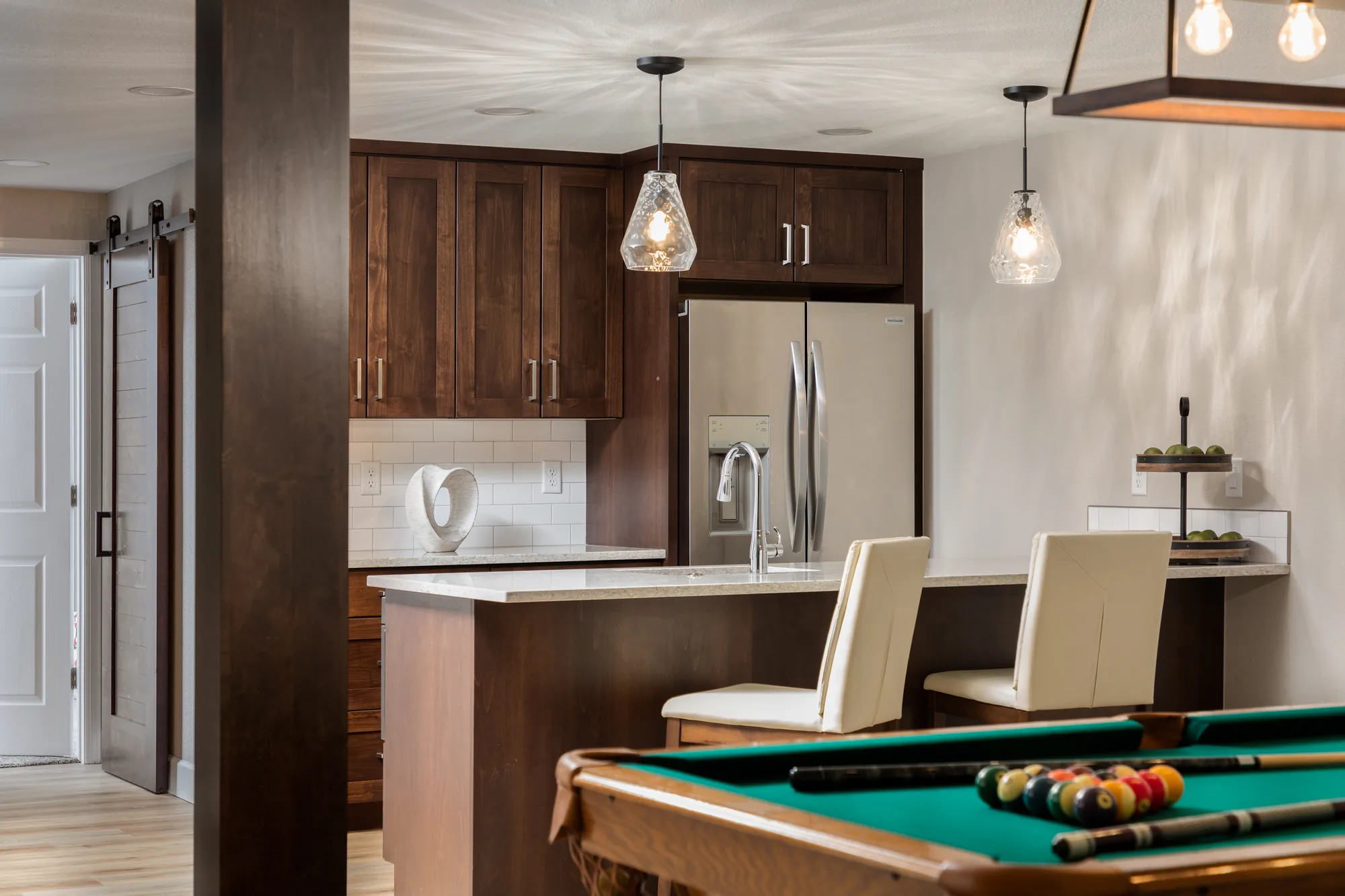 Award winning basement remodel with a billiards room and built in cabinetry